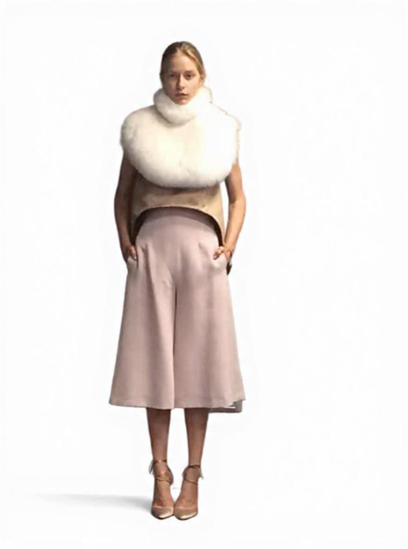A blush culotte look with a white shearling collar, designed by Federica Cavenati