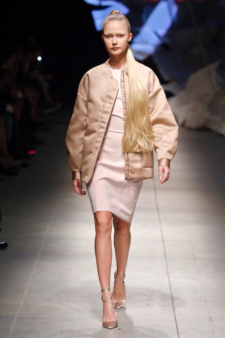 A model on the runway in a champagne bomber and blush satin, designed by Federica Cavenati